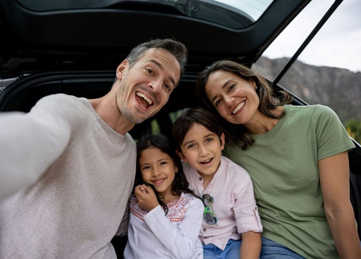 Happy family on road trip with a rental car